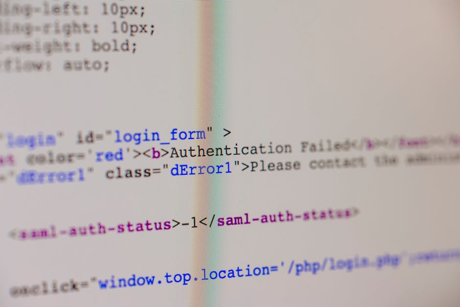 A photograph of a computer screen displaying a web page with visible HTML code, including tags such as 'login form' and error messages like 'Authentication Failed.' The code is shown in different colo
